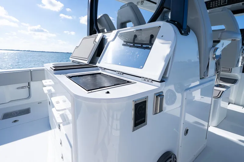 Slide: The Image of Freeman 43 boat cockpit with navigation screens, steering wheel, and ocean view, 2022 model. - 50