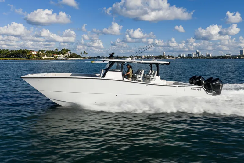 Slide: The Image of 2022 Freeman 43 boat on water with multiple Mercury outboard engines. - 6