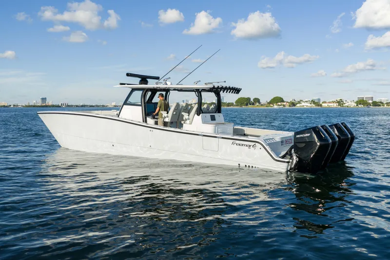 Slide: The Image of 2022 Freeman 43 boat on calm water under a blue sky with clouds. - 7