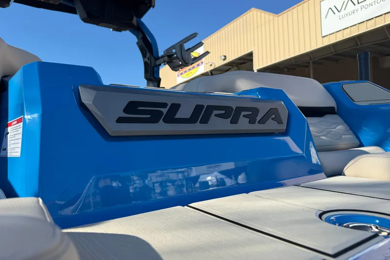 Slide: The Image of 2026 Supra SL 550 boat with blue detailing and luxury seating. - 12