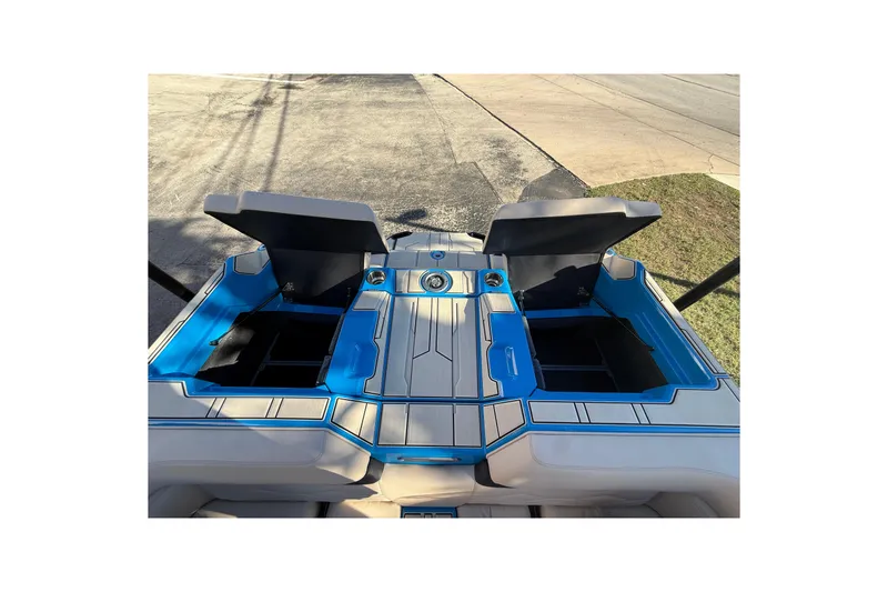 Slide: The Image of 2026 Supra SL 550 boat interior with open storage compartments and blue accents. - 16