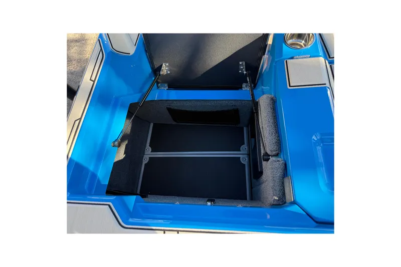 Slide: The Image of 2026 Supra SL 550 boat storage compartment with blue and gray interior. - 17