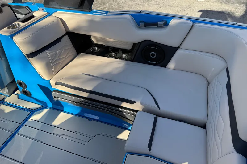 Slide: The Image of Luxurious interior seating of 2026 Supra SL 550 boat with cup holders and speaker system. - 23
