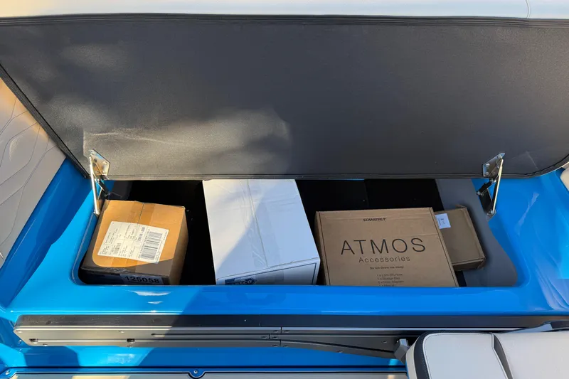 Slide: The Image of Open storage compartment in 2026 Supra SL 550, containing various boxes and accessories. - 24