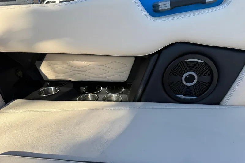 Slide: The Image of 2026 Supra SL 550 interior with cup holders and speaker, featuring elegant white upholstery. - 26