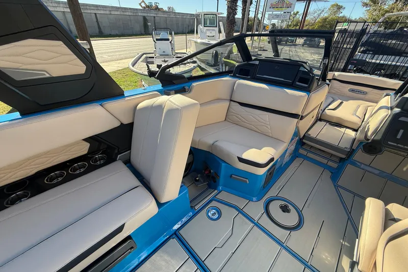 Slide: The Image of 2026 Supra SL 550 boat interior with beige seating and blue accents. - 29