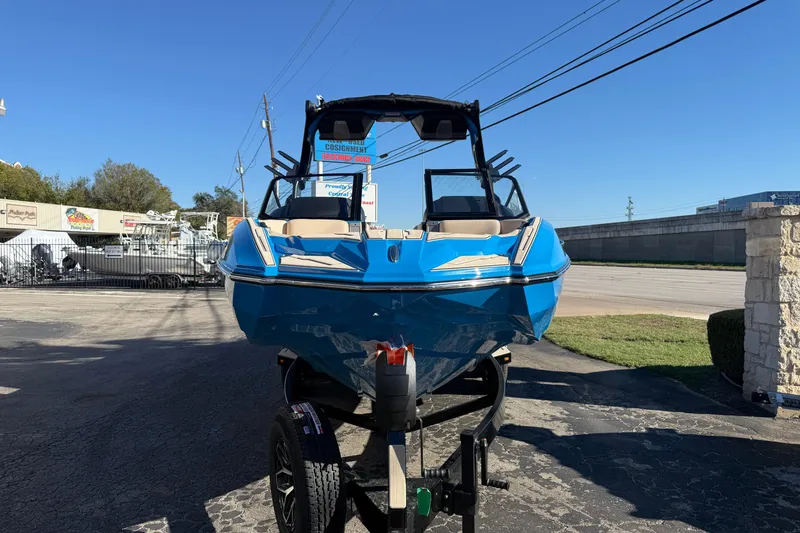 Slide: The Image of 2026 Supra SL 550 boat in vibrant blue on a trailer, outdoor dealership setting. - 3