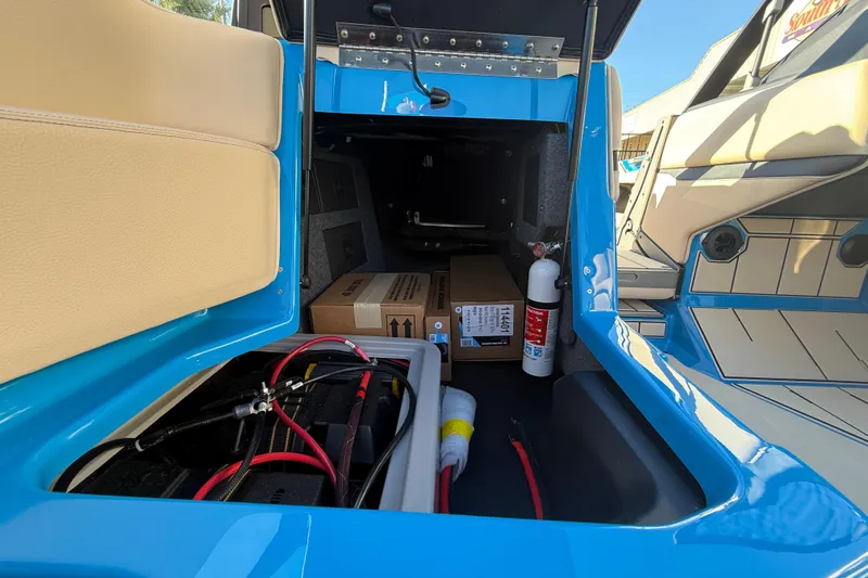 Slide: The Image of 2026 Supra SL 550 interior storage with battery, fire extinguisher, and boxes. - 32