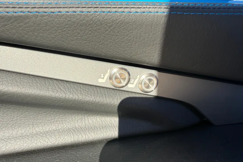 Slide: The Image of 2026 Supra SL 550 interior seat adjustment buttons with blue stitching detail. - 39
