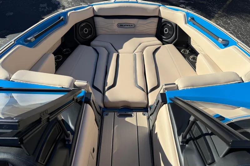 Slide: The Image of 2026 Supra SL 550 boat interior with beige seating and blue accents. - 46