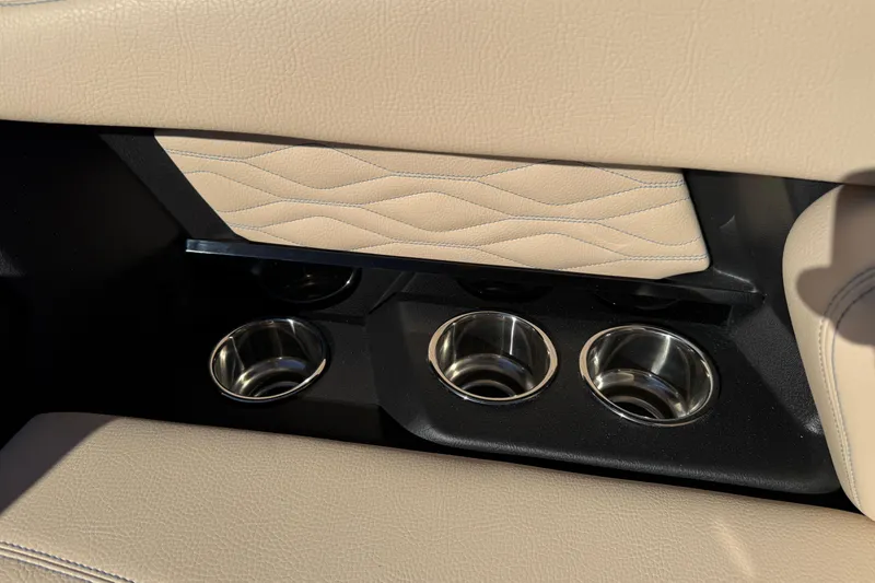 Slide: The Image of 2026 Supra SL 550 interior cup holders with beige leather detailing. - 49