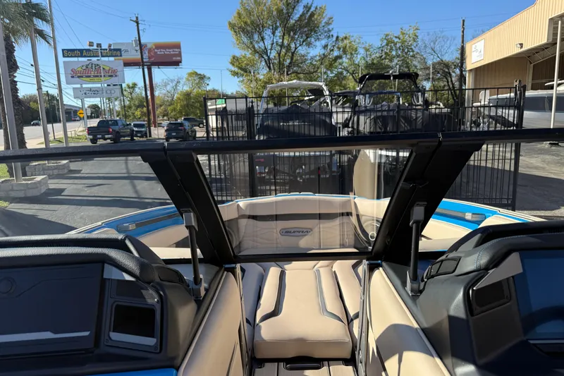 Slide: The Image of 2026 Supra SL 550 boat interior with beige seating, parked at South Austin Marine. - 52