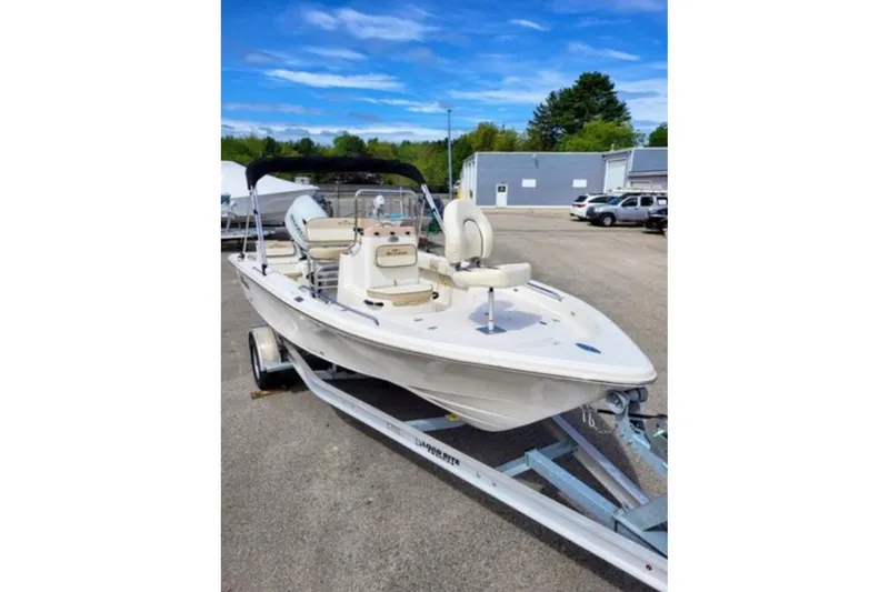 Slide: The Image of 2022 Sea Chaser 21 LX boat on trailer, parked outdoors under blue sky. - 6