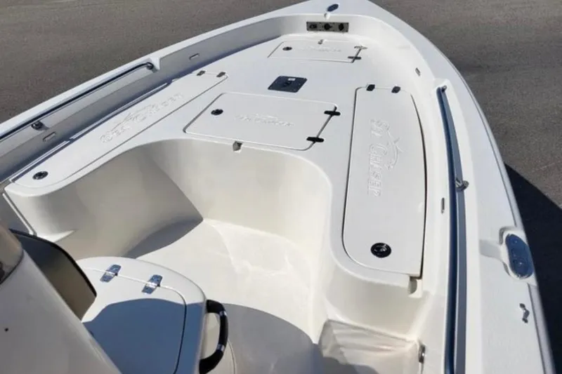 Slide: The Image of 2022 Sea Chaser 21 LX boat interior with storage compartments and seating. - 7