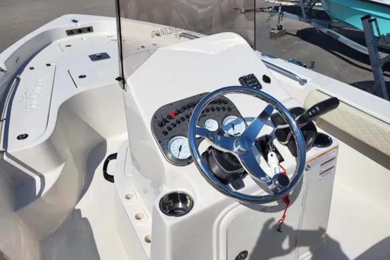 Slide: The Image of 2022 Sea Chaser 21 LX boat dashboard with steering wheel and controls. - 9
