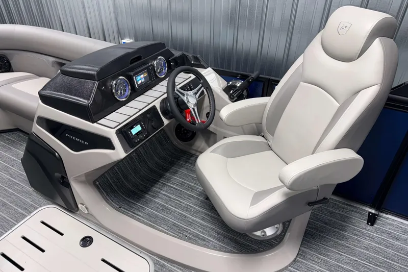 Slide: The Image of 2026 Premier 210 Sunsation RL Tritoon helm with modern dashboard and comfortable captain's chair. - 10
