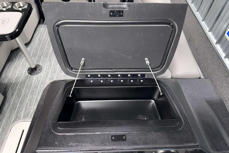 Slide: The Image of Open storage compartment in 2026 Premier 210 Sunsation RL Tritoon boat interior. - 12