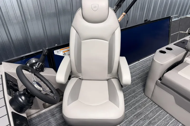 Slide: The Image of Captain's chair and steering wheel of 2026 Premier 210 Sunsation RL Tritoon boat. - 13