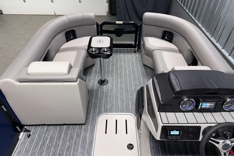 Slide: The Image of 2026 Premier 210 Sunsation RL Tritoon interior with plush seating and modern dashboard. - 17