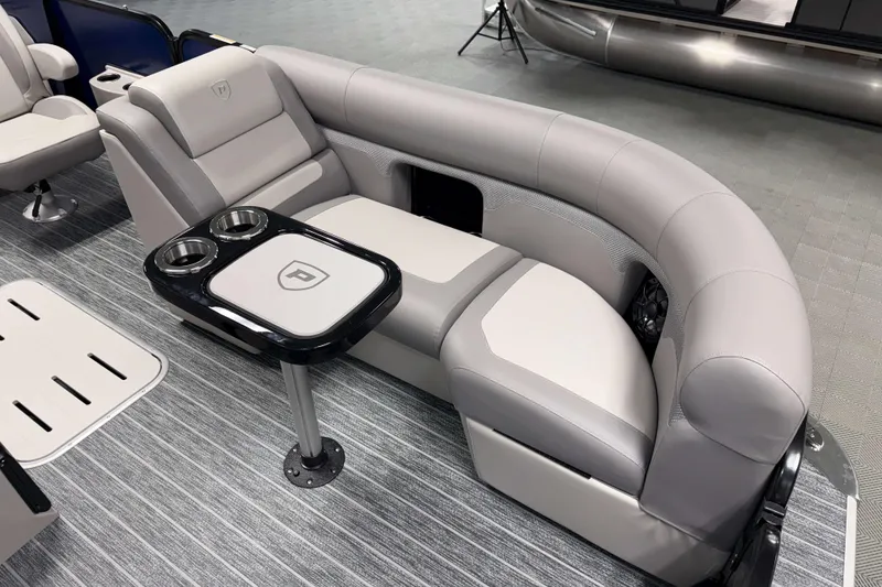 Slide: The Image of 2026 Premier 210 Sunsation RL Tritoon interior with plush seating and cupholders. - 18