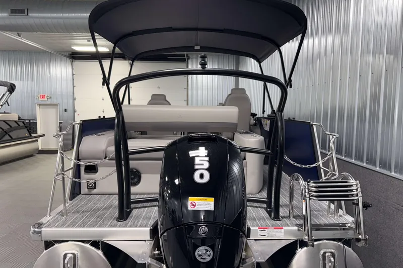 Slide: The Image of 2026 Premier 210 Sunsation RL Tritoon with outboard motor in showroom. - 4