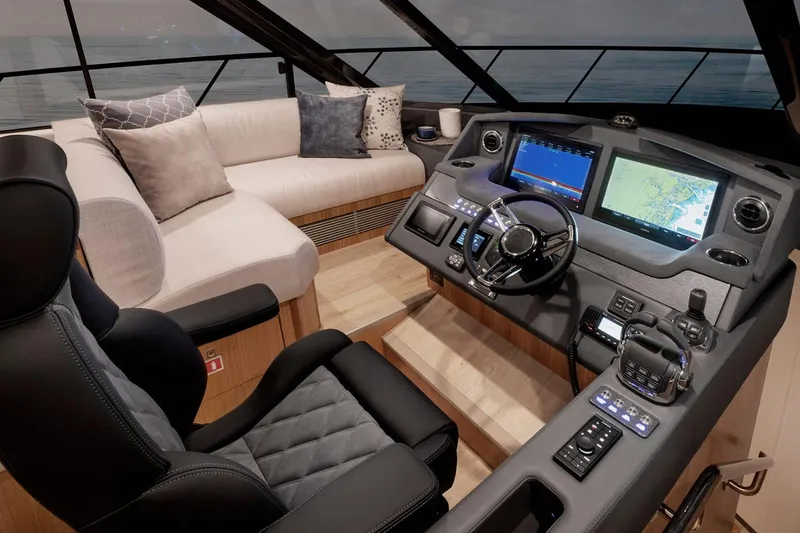 Slide: The Image of Manufacturer Provided Image: Luxurious interior of 2023 Riviera 5400 Sport Yacht with modern helm and plush seating. - 10