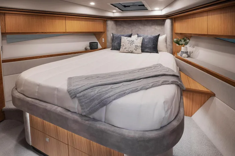 Slide: The Image of Manufacturer Provided Image: Luxurious bedroom interior of 2023 Riviera 5400 Sport Yacht with cozy bedding. - 13