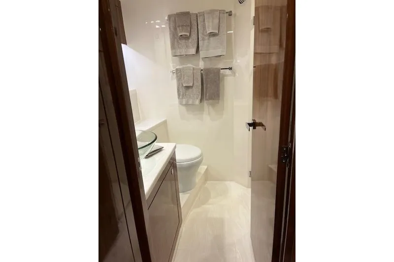 Slide: The Image of Luxurious bathroom in 2023 Riviera 5400 Sport Yacht with modern fixtures and elegant design. - 20