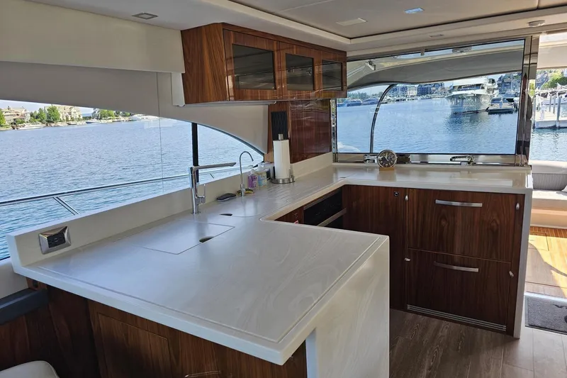 Slide: The Image of Luxurious interior of 2023 Riviera 5400 Sport Yacht with modern kitchen and waterfront view. - 3