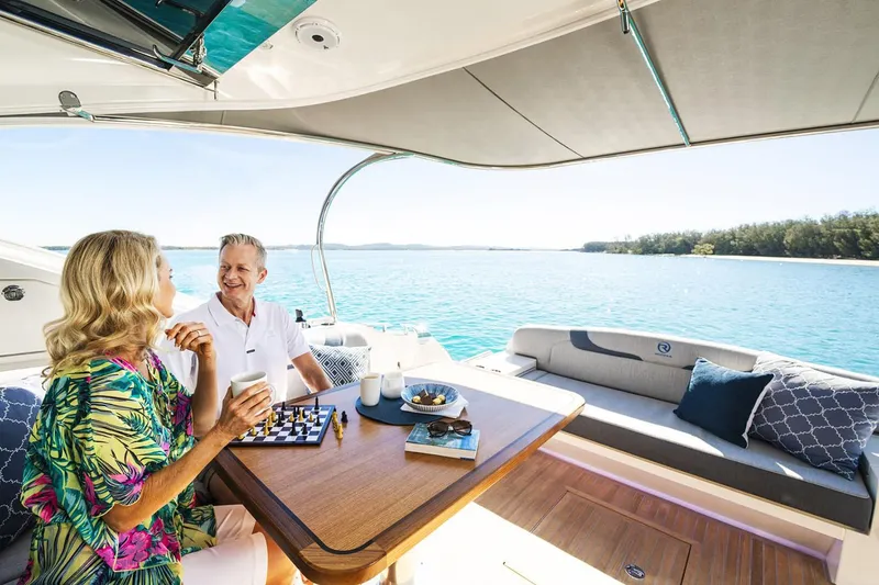 Slide: The Image of Manufacturer Provided Image: Couple enjoying leisure time on 2023 Riviera 5400 Sport Yacht. - 6