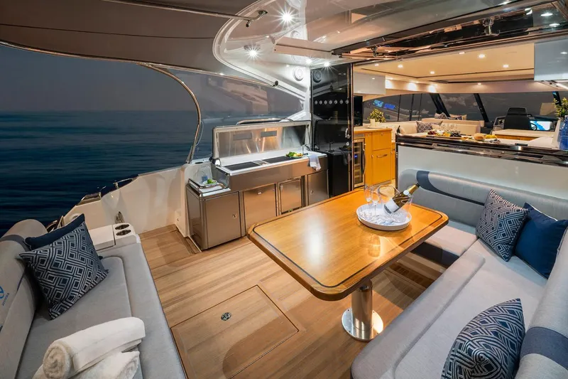 Slide: The Image of Manufacturer Provided Image: Luxurious interior of 2023 Riviera 5400 Sport Yacht with elegant dining area and ocean view. - 7