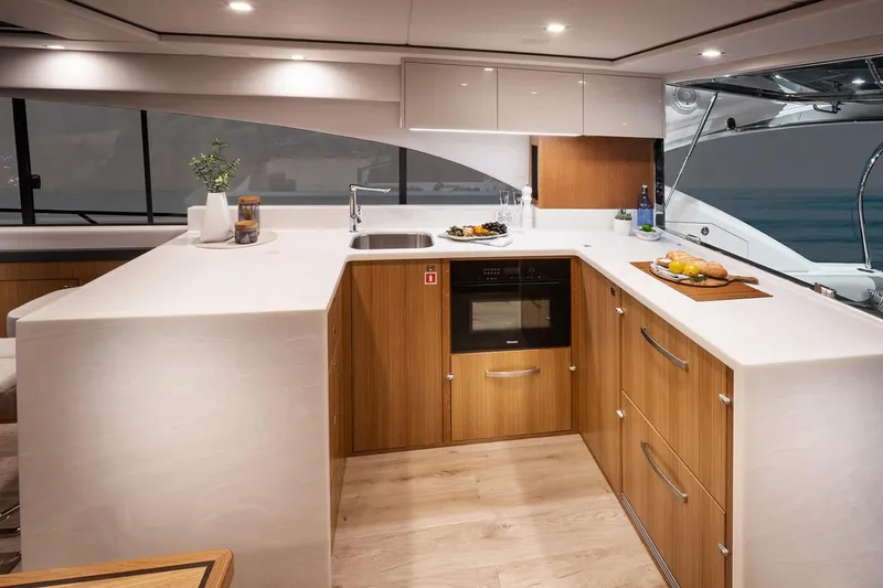 Slide: The Image of Manufacturer Provided Image: Modern kitchen interior of 2023 Riviera 5400 Sport Yacht with sleek design and ocean view. - 9
