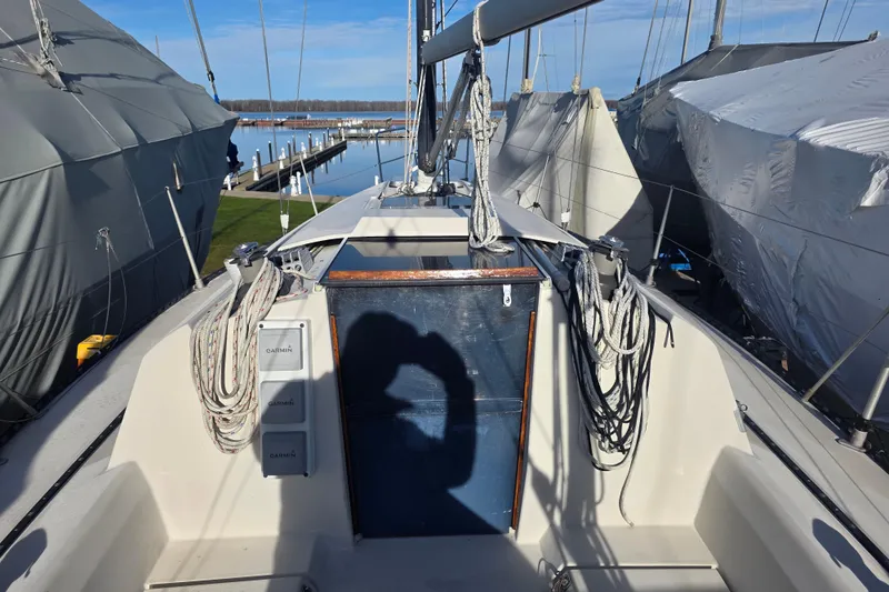 Slide: The Image of 1985 Express Yachting Express 30 sailboat deck with ropes and marina view. - 10