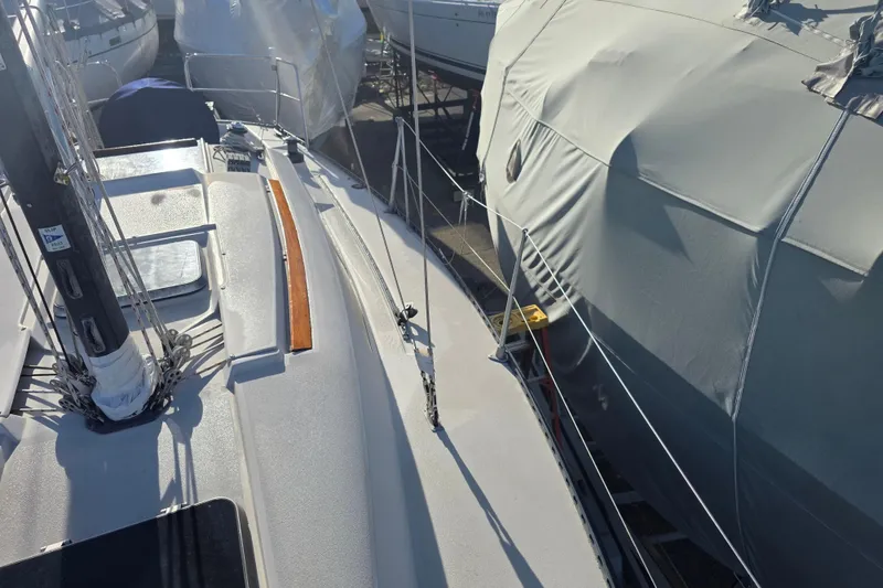 Slide: The Image of 1985 Express Yachting Express 30 sailboat deck view in marina. - 11