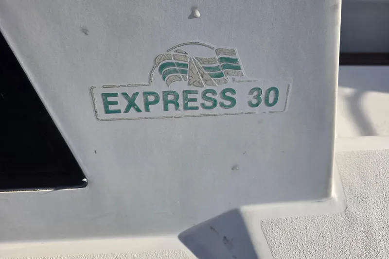 Slide: The Image of 1985 Express Yachting Express 30 logo on yacht exterior. - 13