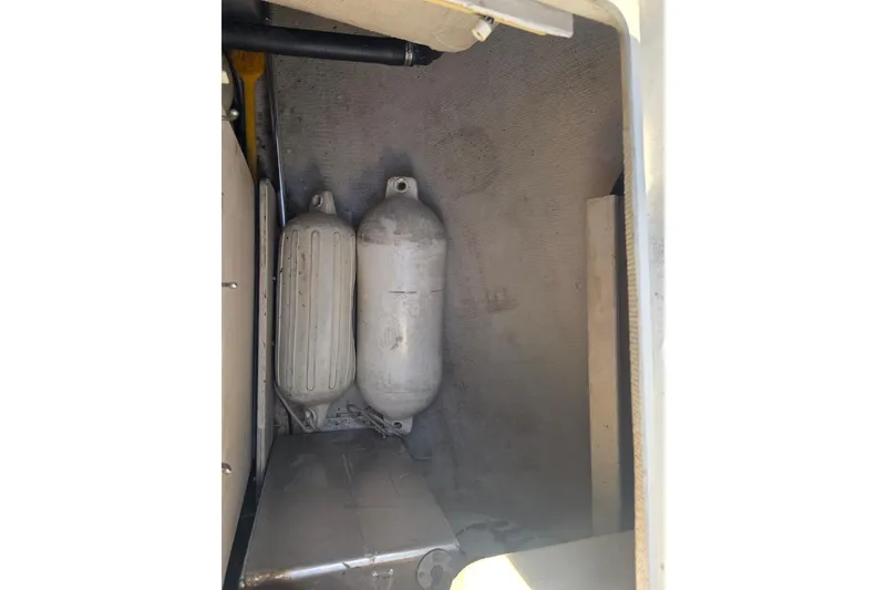 Slide: The Image of Storage compartment of 1985 Express Yachting Express 30 with fenders and equipment. - 17