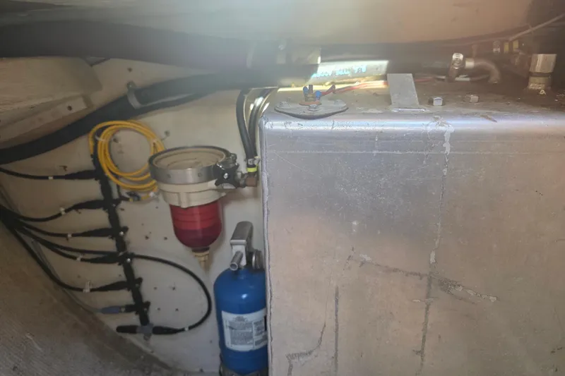 Slide: The Image of Engine compartment of 1985 Express Yachting Express 30, featuring fuel filter and wiring. - 21