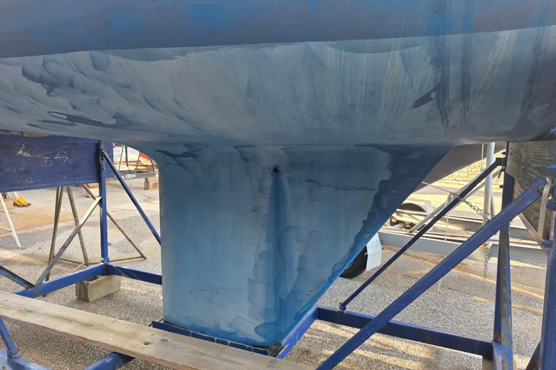 Slide: The Image of 1985 Express Yachting Express 30 sailboat hull on stands, undergoing maintenance. - 28