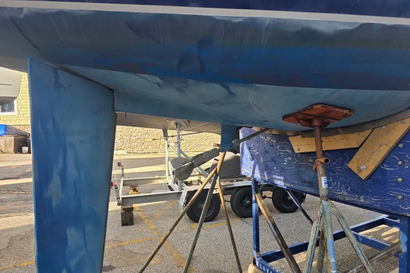 Slide: The Image of 1985 Express Yachting Express 30 sailboat hull on a trailer, undergoing maintenance. - 30