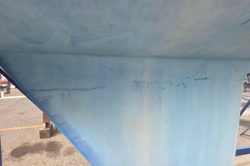 Slide: The Image of Close-up of 1985 Express Yachting Express 30 hull with visible surface cracks. - 33