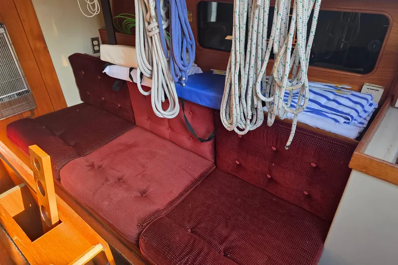 Slide: The Image of Interior of 1985 Express Yachting Express 30 with maroon seating and nautical ropes. - 35