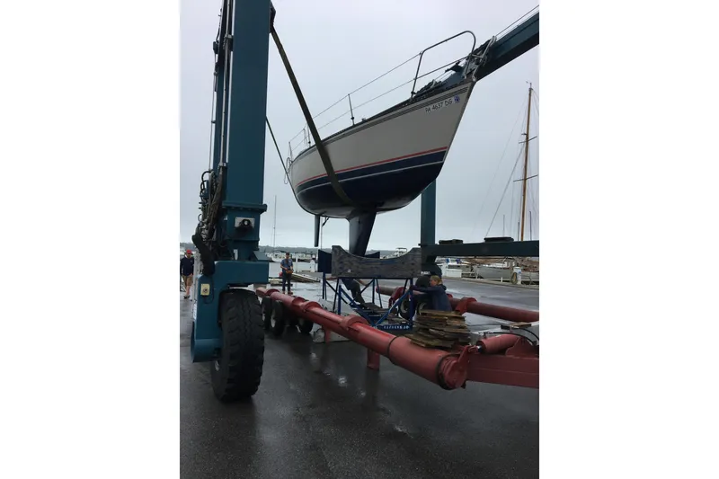 Slide: The Image of 1985 Express Yachting Express 30 sailboat being lifted by a large crane. - 41