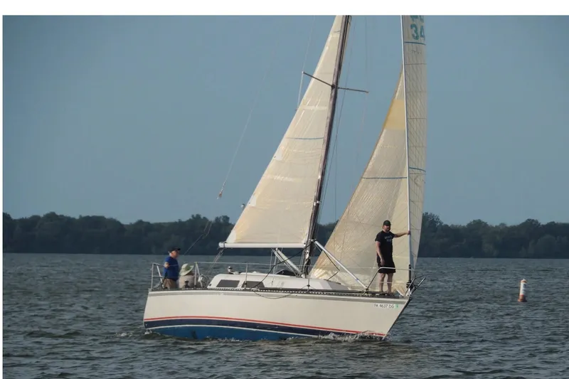 Slide: The Image of Sailboat on water, 1985 Express Yachting Express 30, two people onboard, clear sky. - 43