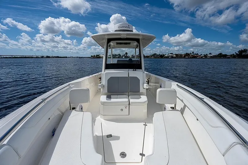 Slide: The Image of 2021 Pursuit S 288 Sport boat interior with seating, on a sunny day at sea. - 11
