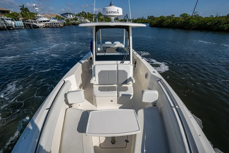 Slide: The Image of 2021 Pursuit S 288 Sport boat cruising on a scenic waterway. - 14