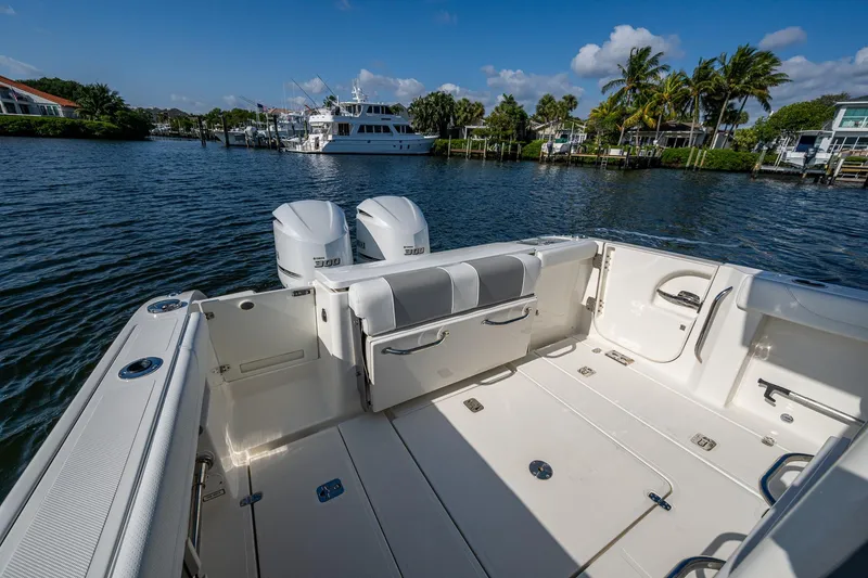 Slide: The Image of 2021 Pursuit S 288 Sport boat with dual engines on a scenic waterfront. - 27