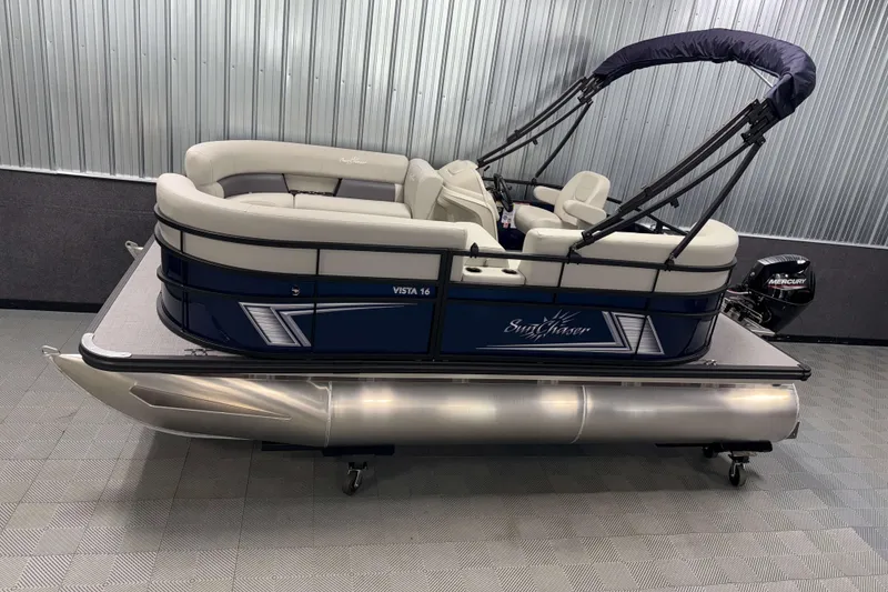The Image of 2026 SunChaser Vista 16 LR pontoon boat in showroom, featuring sleek design and comfortable seating. - 0