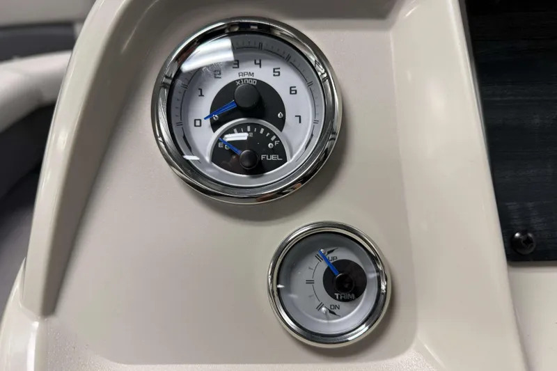 Slide: The Image of Dashboard gauges of 2026 SunChaser Vista 16 LR boat, showing RPM and trim indicators. - 10