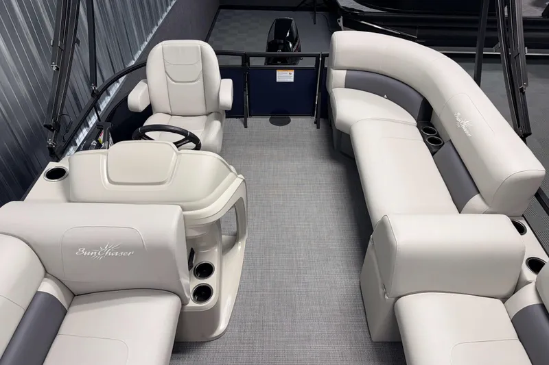 Slide: The Image of 2026 SunChaser Vista 16 LR pontoon boat interior with plush seating and steering console. - 11