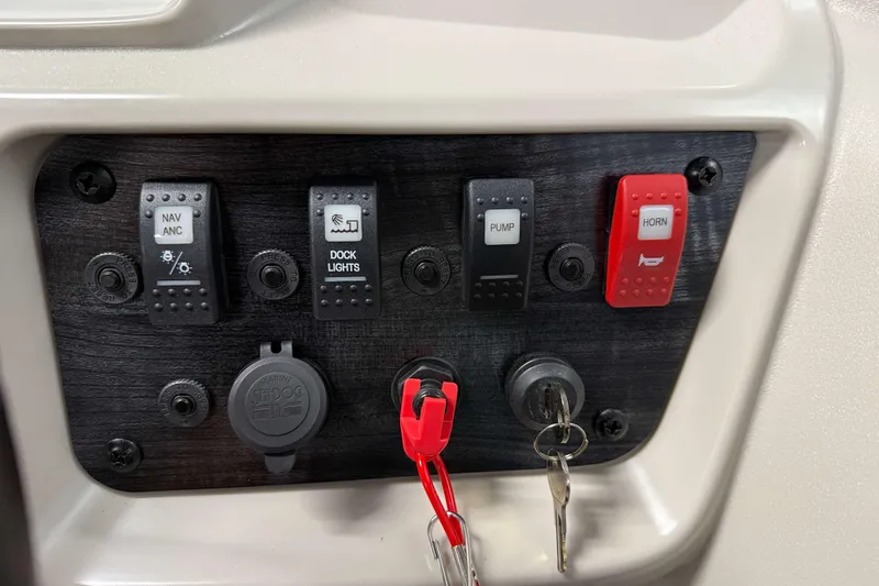 Slide: The Image of Control panel of 2026 SunChaser Vista 16 LR boat with switches and ignition keys. - 8